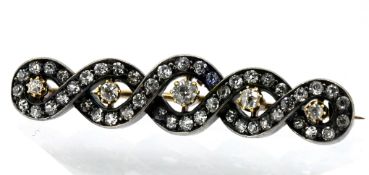 A Victorian diamond set brooch, with interwoven 'infinity' or ribbon style design, set in gold,