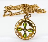 An antique floral pendant and 9ct gold chain, set with peridot and a seed pearl in the centre, total