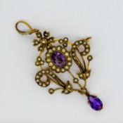 An Art Nouveau amethyst and seed pearl pendant, with an openwork interlaced design, mounted in 9ct
