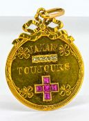 An 18ct yellow gold ‘Love Medal’ pendant, inscribed Jamais Toujours (Forever and Always), set with