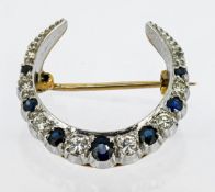 A small diamond and sapphire crescent brooch, mounted in 9ct yellow gold, makers mark FRS Ltd,