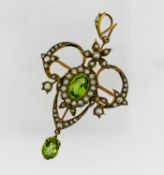 An Edwardian peridot and pearl pendant/brooch, with scroll and floral motifs, mounted in yellow gold