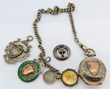 A silver watch chain with silver coin case attached and medallion together with another silver