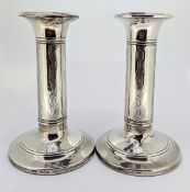 A pair of Edwardian silver candlesticks, with wave decoration, hallmarked Birmingham 1905,