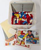 A collection of vintage Lego pieces and instructions.