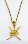 A gold emblem of Oman, on a 18ct yellow gold chain, total weight 8g.