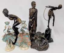 A collection of bronzed style figurines, of resin and metal, including a hoop dancer, African