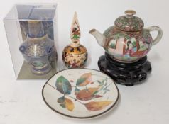 A miniature Chinese Famille Rose style teapot, on a wooden stand, together with a small dish, pot,