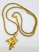 A 22ct gold dolphin pendant on a 22ct gold chain, approx 17.3g.