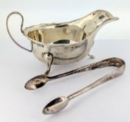 A silver cream boat, hallmarked Sheffield 1934, with a pair of sugar tongs, total weight approx