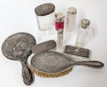 A collection of silver mounted dressing table items, to include a silver hand mirror with embossed