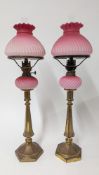 A pair of 19th century pink glass and brass oil lamps, height approx 58cm.