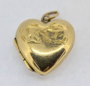 A small heart locket, set in 9ct yellow gold back and front, approx 2.3g.