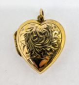 A small heart locket, set in 9ct yellow gold back and front, approx 3.4g.