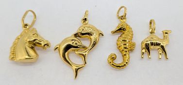 Four 18ct gold charms, approx 8.5g.