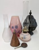 A small pink glass oil lamp, together with shades, metal urn, and other items.