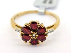 Gemporia, a Songea ruby and diamond set ring, set in 9k yellow gold, size S, with certificate of