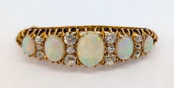 An antique opal and diamond bar brooch, set with five oval cabochon cut opals, with graduated