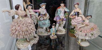 A collection of German style ceramic figurines, to include a peasant figure with Meissen style