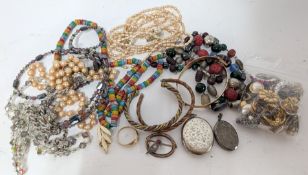 A small collection of costume jewellery including a silver locket, necklaces, earrings etc.
