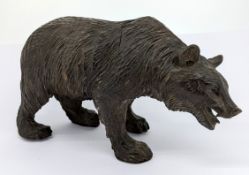 A black forest style carved wood bear figurine, length approx 18cm.