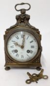 A 19th century elaborate brass clock, makers mark to Roman enamel dial, height approx 20cm.