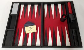 Prada, a Tessuto Backgammon playing set, featuring a black tessuto-covered case, opening to a