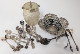 A collection of white metal tourist tea spoons, together with a silver plated jam pot, sugar