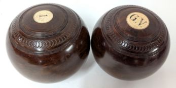 A pair of wooden bowls, marked '1' and 'G.V.'. (2)