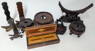 A collection of Chinese carved wooden plate and pot display stands, together with a cased cribbage