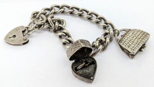 A silver charm bracelet set with two silver charms, approx 39.6g