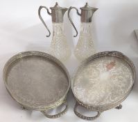 A pair of cut glass silver plated decanters, together with two silver plated trays. (4)