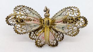 A butterfly brooch, marked 800.