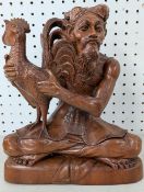A carved wooden figure of an Asian farmer with Cockerel, height approx 31cm.
