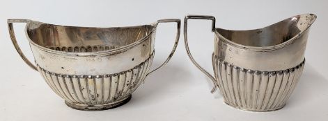 A silver Queen Anne style sugar pot and milk jug, hallmarked Birmingham 1898 / London 1905,