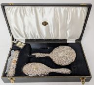 A silver hairbrush set, to include mirror, brush, and clothes brush, hallmarked Birmingham 1978,