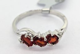 Gemporia, a Songea ruby and white zircon set ring, set in 9k white gold, size Q, with certificate of