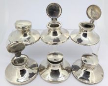 A collection of six silver capstan inkwells, total weight approx 19.74 (filled).