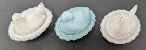 Three moulded glass nesting hen boxes, two of white ground and another of blue. (3)