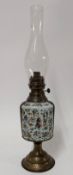 A 19th century painted floral decorated on white ceramic oil lamp, height approx 57cm.