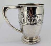 An Edwardian silver Christening mug, decorated with embossed Noah's Ark figures and animals