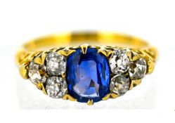 A Victorian sapphire and diamond ring, claw set to the centre with an oval-cut sapphire and set each