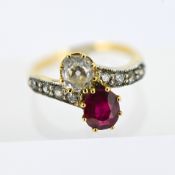 An antique toi et moi diamond and synthetic ruby ring, claw set with an old cushion-cut diamond,