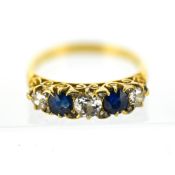A diamond and sapphire five stone ring, claw set with three old-cut diamonds, and two oval-cut