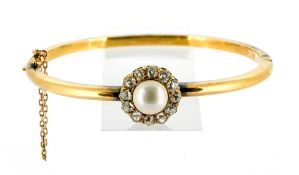 An Edwardian pearl and diamond bangle, the mabe pearl set centrally with a surround of old-cut