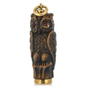 An antique carved owl pencil, the carved owl (possibly carved wood), set with two red stone cabochon