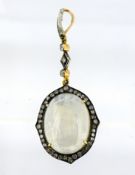 A moonstone and diamond pendant, claw set with an oval-cut moonstone cabochon, measuring approx.