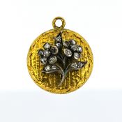 A Georgian diamond keepsake pendant, a circular carved pendant with a floral overlay grain set