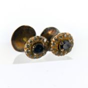 A pair of sapphire and diamond cluster stud earrings, each claw set with an oval-cut sapphire,