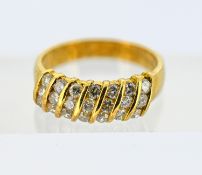 An 18ct gold diamond ring, channel set with seven rows of three brilliant-cut diamonds (twenty-one
